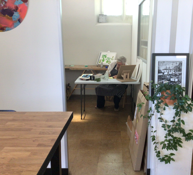 Glenda Wood working in the studio at the Chapel. Behind her is a water colour cut out she had been working on.