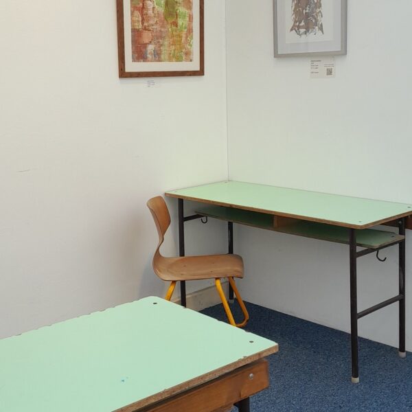 Image of the project space at Amanartis at the Harlequin showing the shared work area with two desks, chairs and shelving